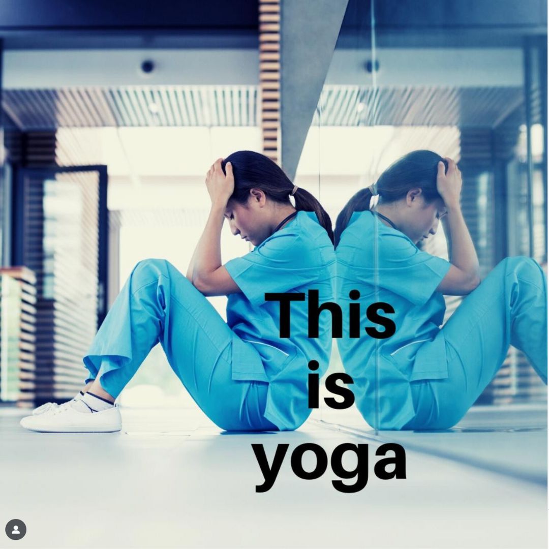 A nurse wearing scrubs sits on the ground in the hospital leaning against the wall, her head in her hands. Text reads: This is Yoga. 